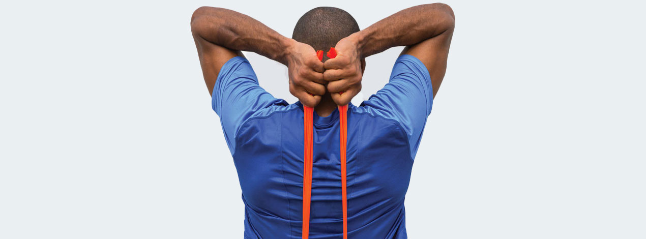 Man exercising with elastic bands.